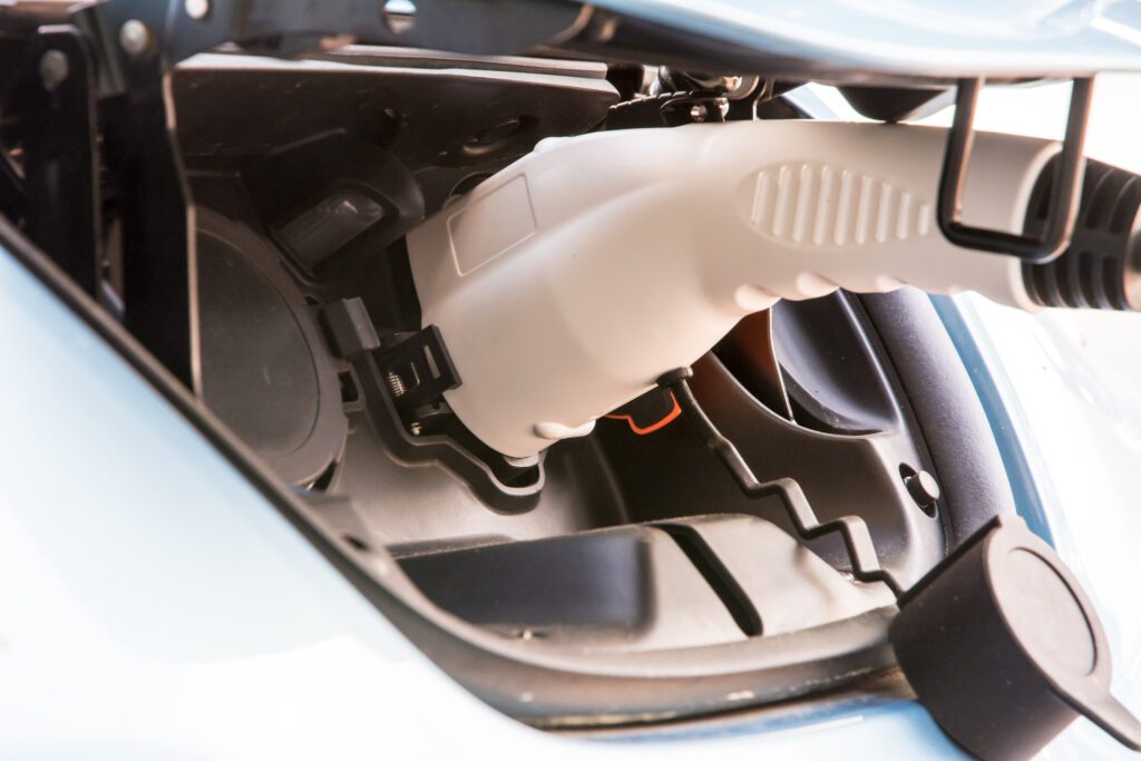 an electric car plugged into an outlet being charged